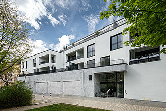 Complexe d'immeubles modernes à Munich, comprenant des appartements et un supermarché Edeka.