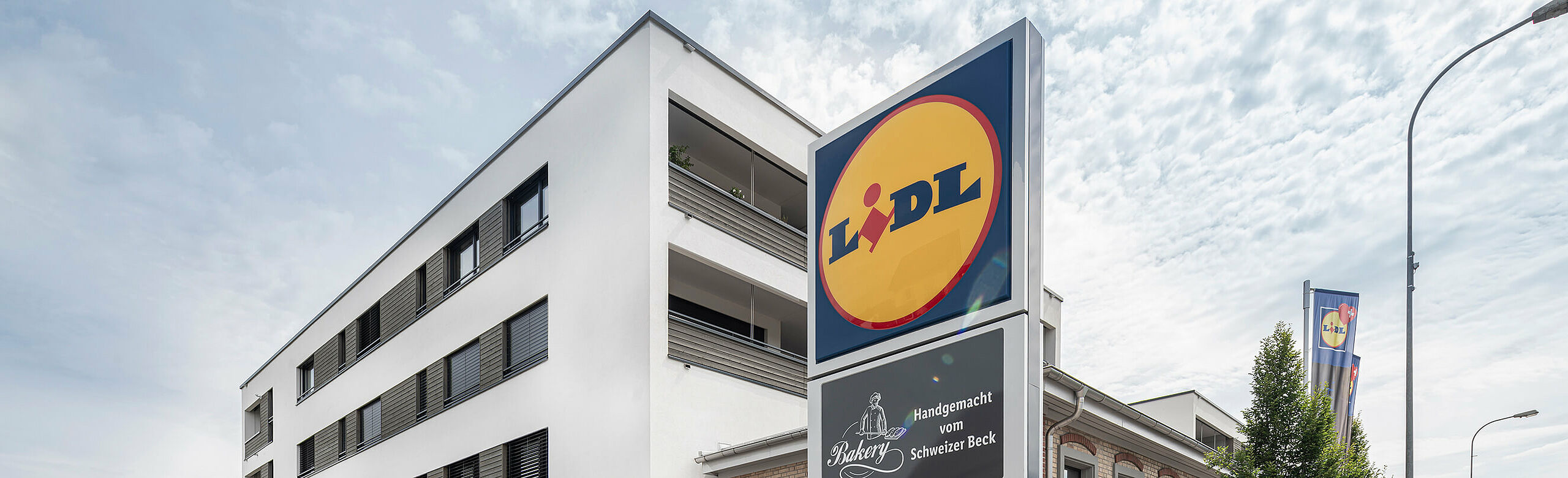 Lidl with flats above in a mixed-use building in Switzerland.