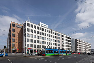 Vue du quartier urbain Seetor City Campus à Nuremberg avec un tramway devant le bâtiment.