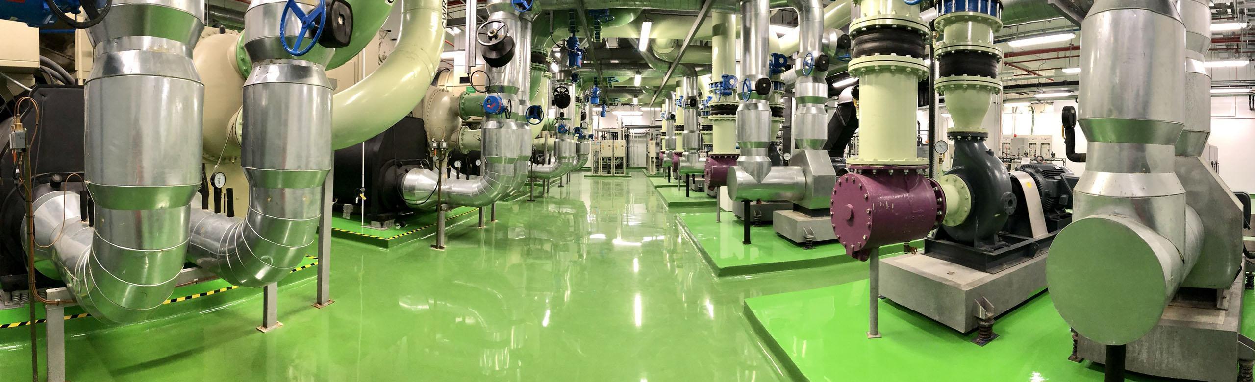 Technical centre with many machines on a green industrial floor.